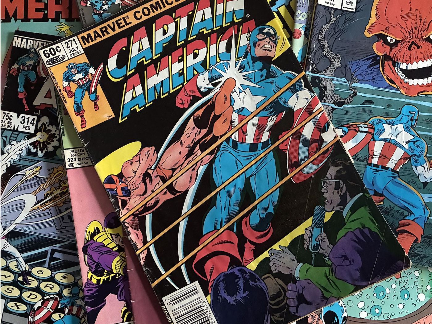 A spread of vintage Captain America comics gathered as source material